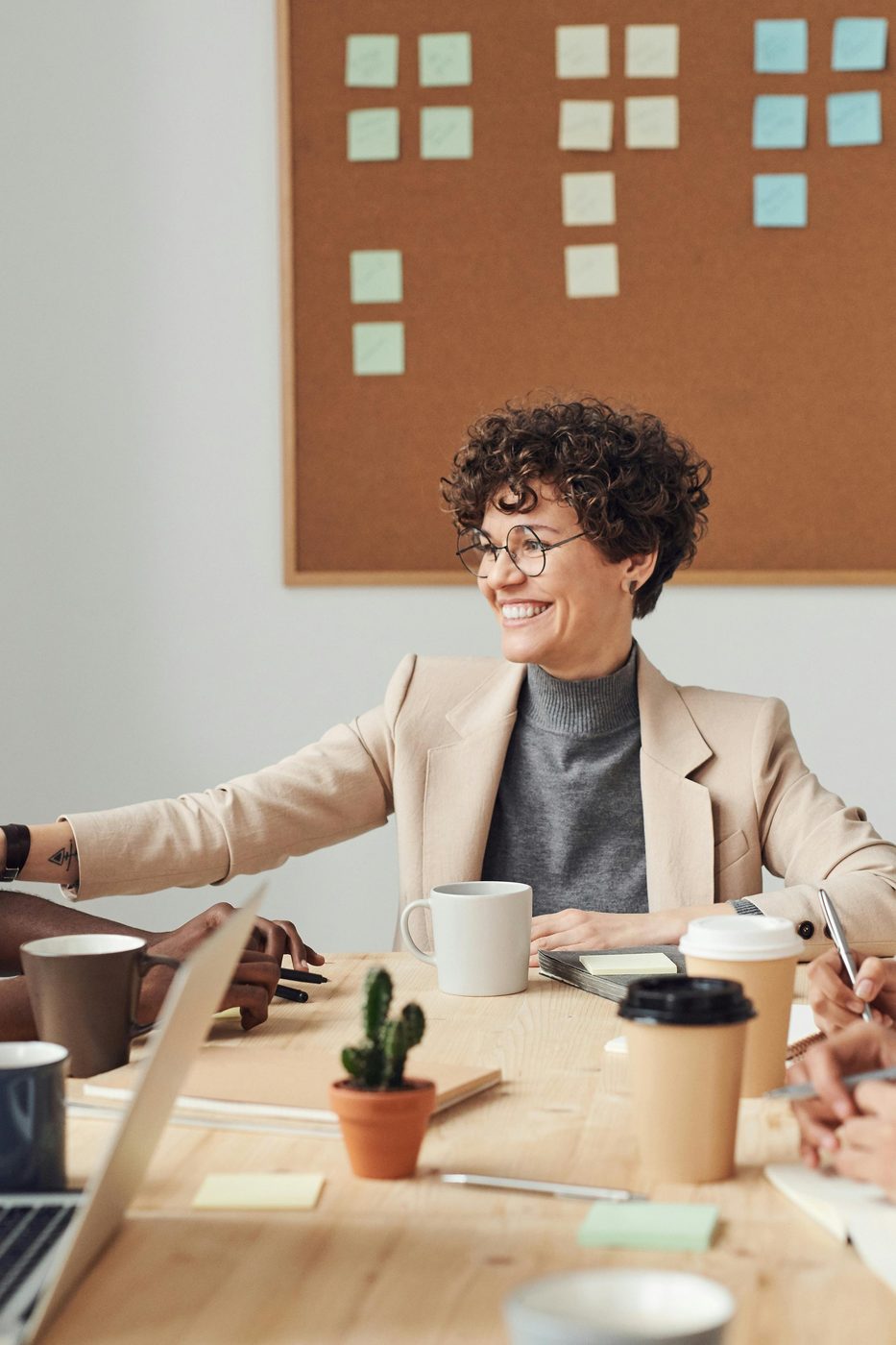 A diverse team of coworkers smiling and collaborating around a conference table
